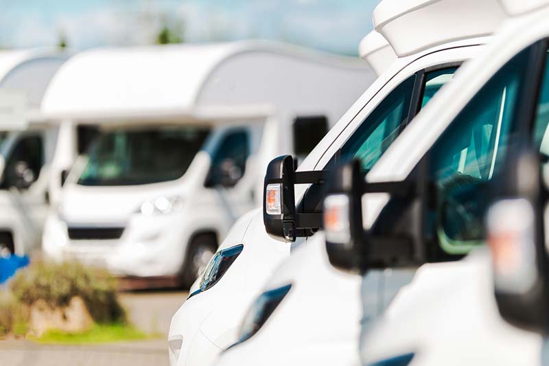 Parking lot filled with recreation vehicles for sale after an rv inspection