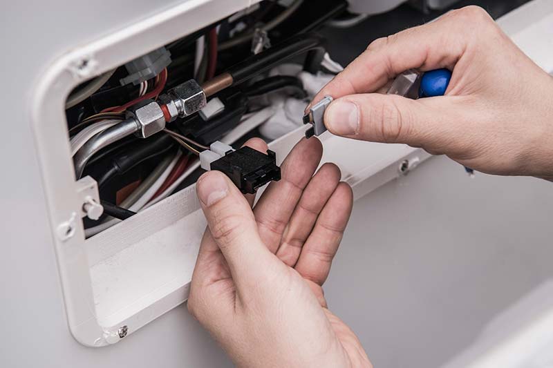 Person checking the appliances fuses during an RV inspection 