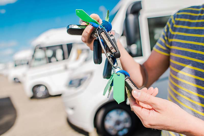 Person holding keys to a recreation vehicle they are selling after an rv inspection is preformed