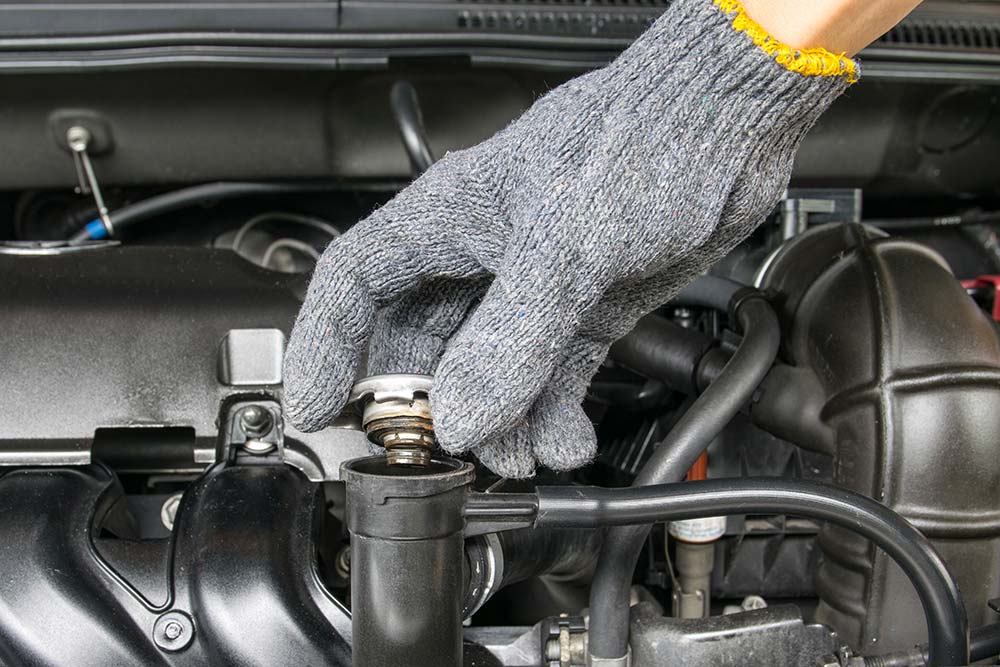 Hand checking the fluids in the engine while preforming rv inspection services